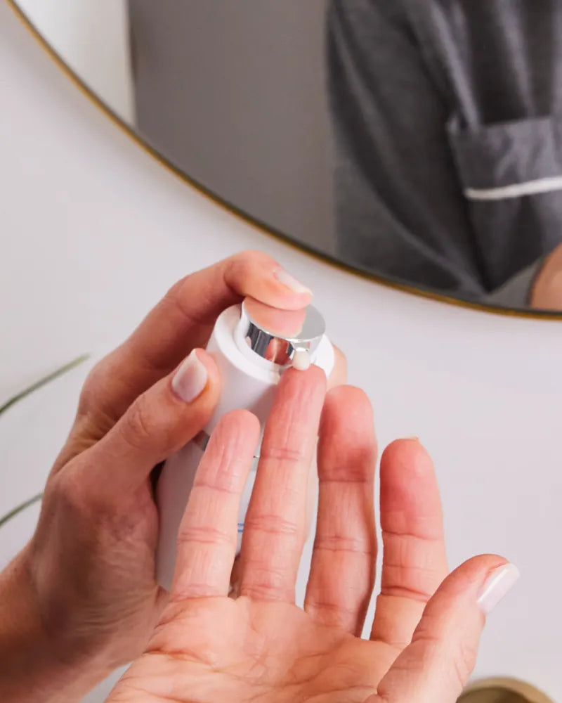 Regenerative ECM Eye Complex cream being dispensed onto finger in gall