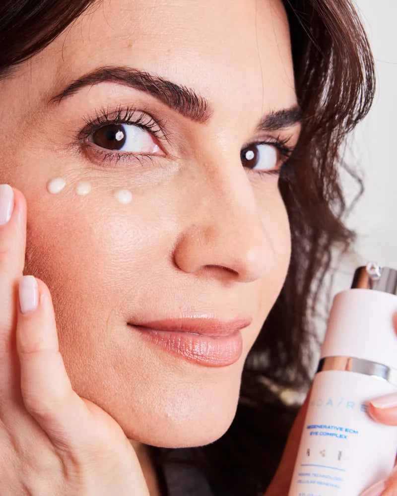Woman applying MDAiRE 3-Step Glow Trio eye cream with gentle dots unde