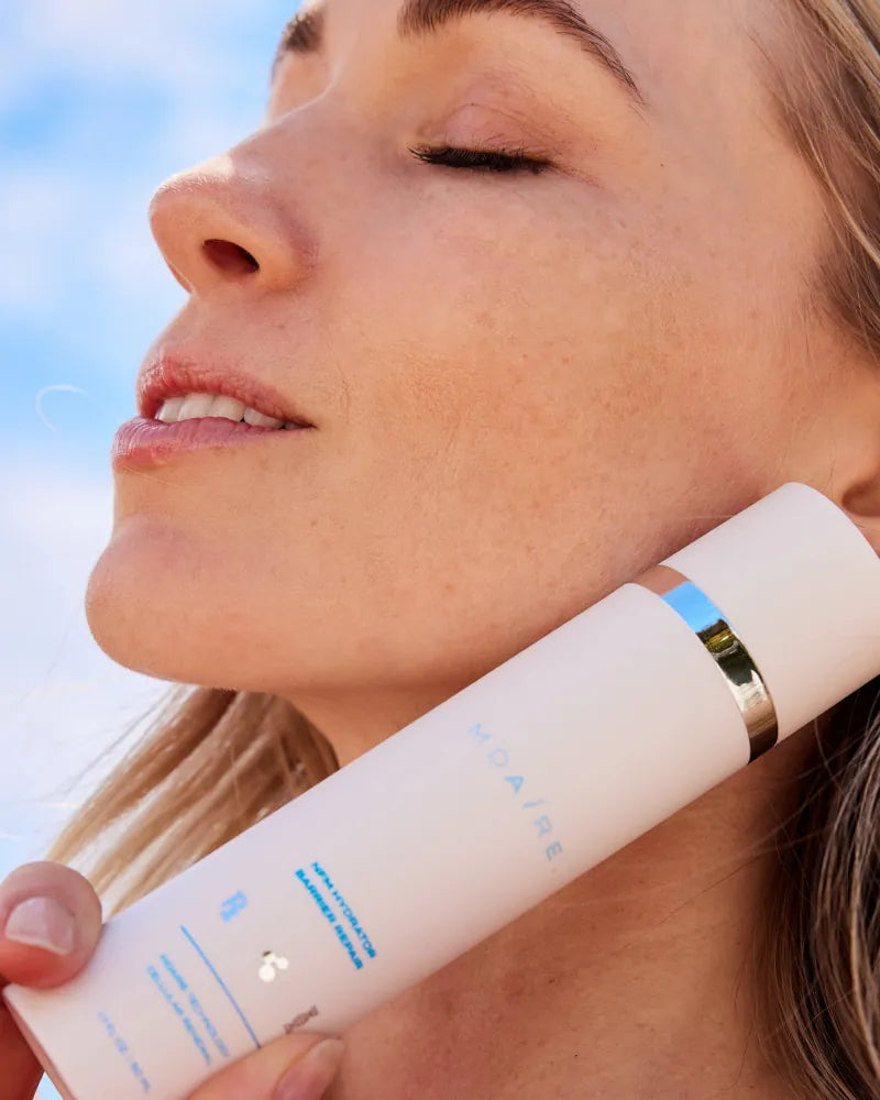 Close-up of woman holding NMF Hydrator Barrier Repair by Dr. Stefani K