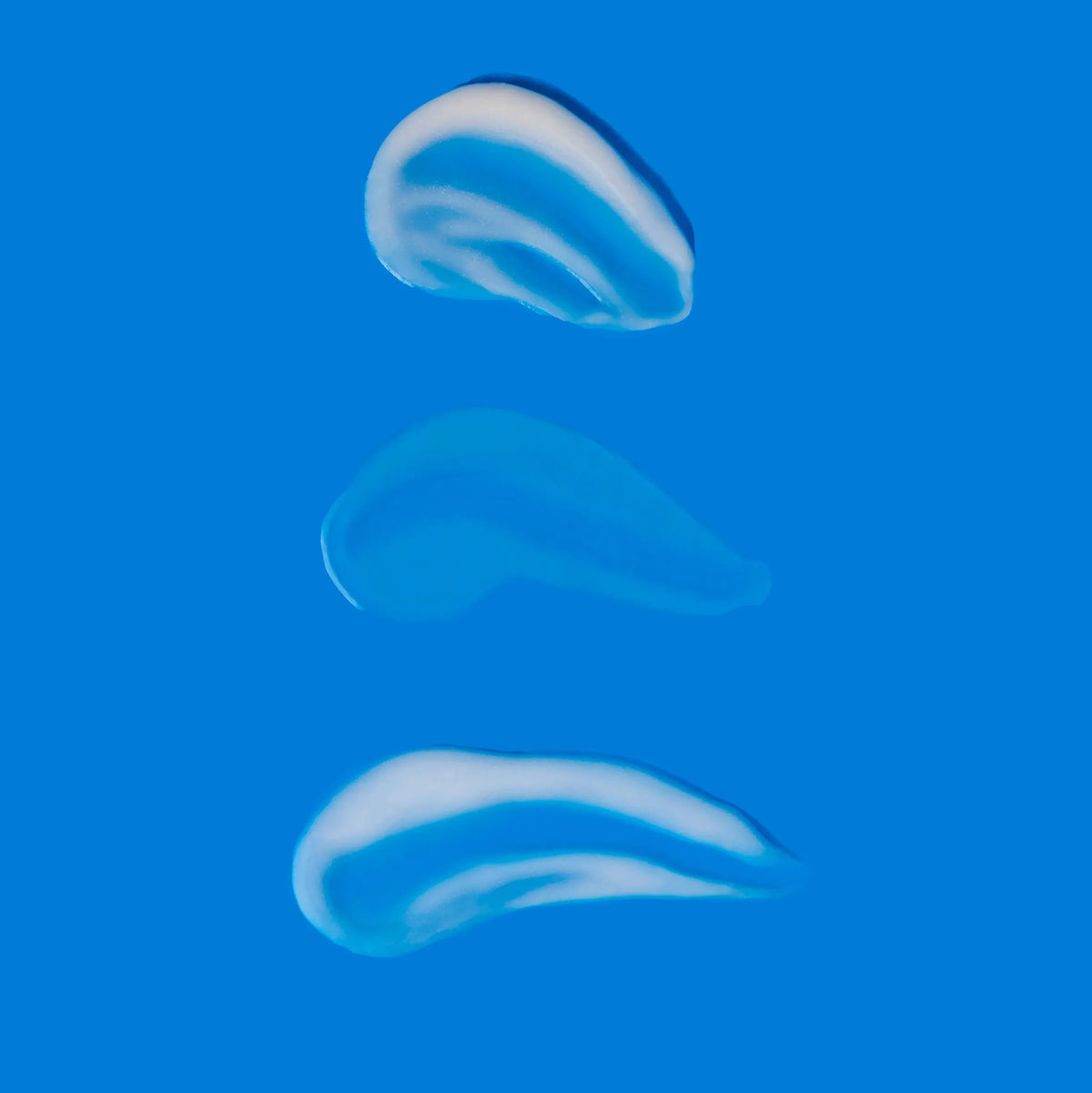 Brightening Trio product textures on blue background showing hydration