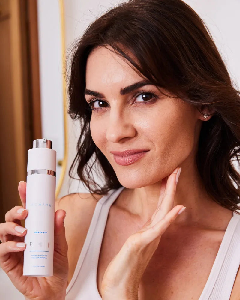 Woman holding Triple Threat Trio bottle near jawline demonstrating ski