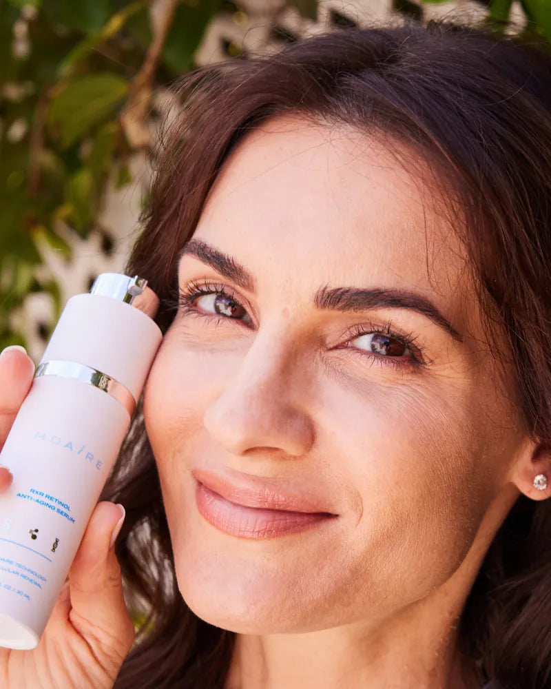 Close-up of woman holding RXR Retinol Anti-Aging Serum from Daily Skin